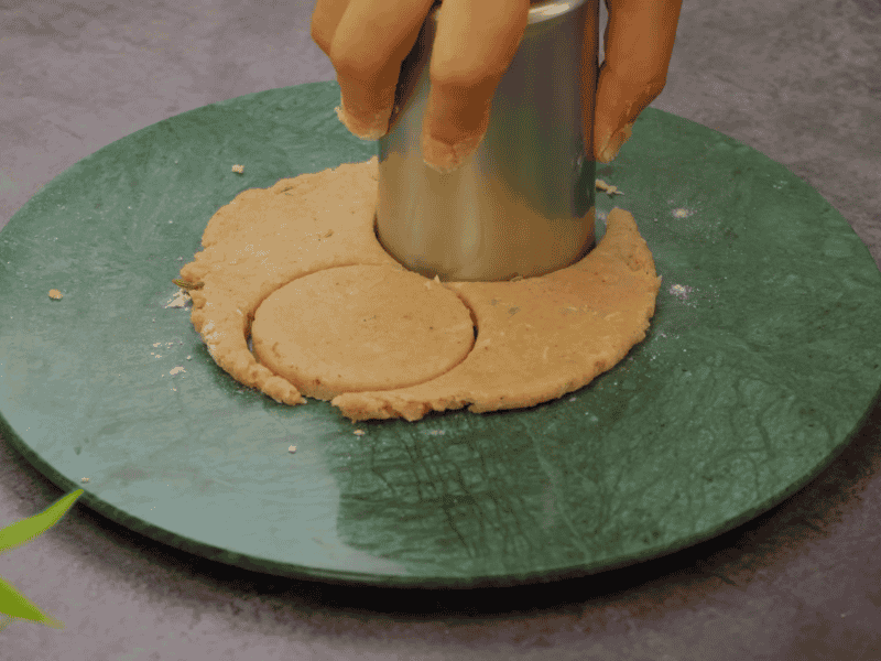 Shaping Thekua dough into small round and oval pieces