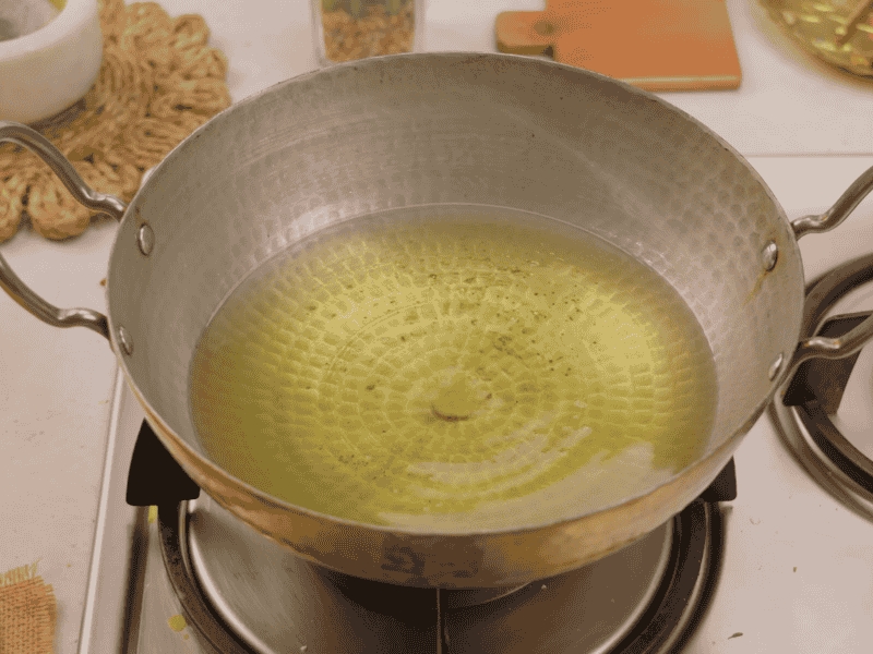 Oil in a pan for deep frying Thekua