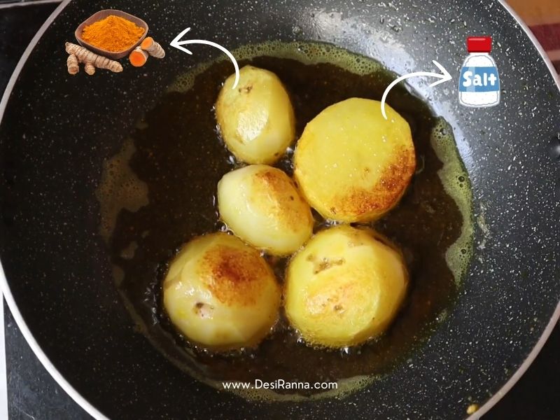 Golden fried potato pieces in a pan